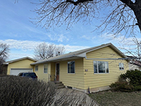 a tree in front of a house