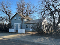 a tree in front of a house