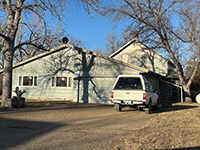 a tree in front of a house