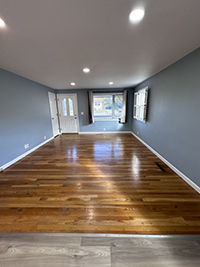 a close up of a hard wood floor next to a window